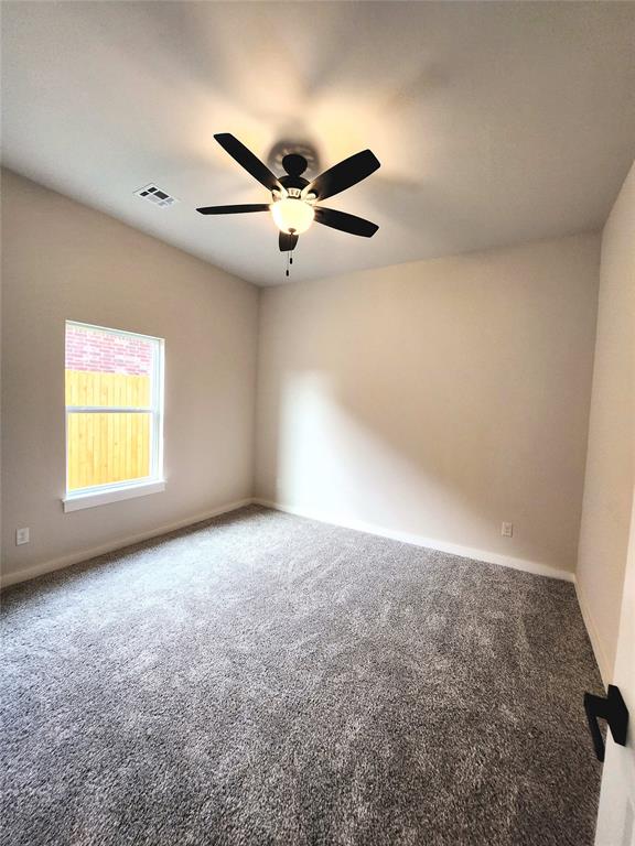 carpeted empty room with ceiling fan