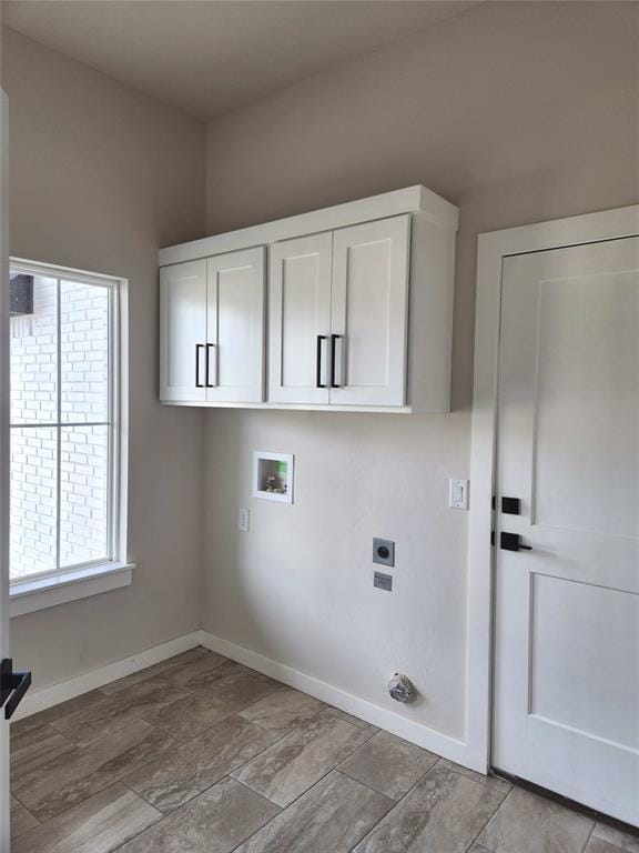 laundry room with cabinets, washer hookup, a wealth of natural light, and electric dryer hookup