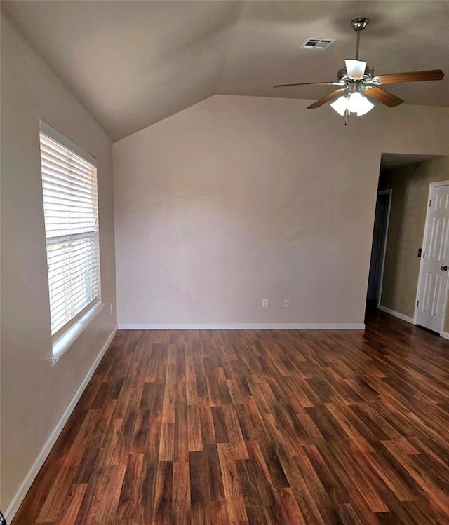 unfurnished room with ceiling fan, dark hardwood / wood-style flooring, and vaulted ceiling