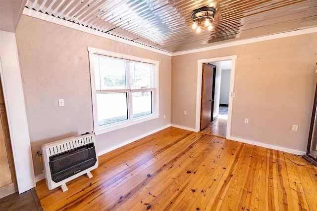 interior space with hardwood / wood-style floors and heating unit