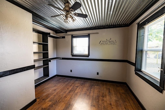 unfurnished room featuring ceiling fan, dark hardwood / wood-style flooring, and a wealth of natural light