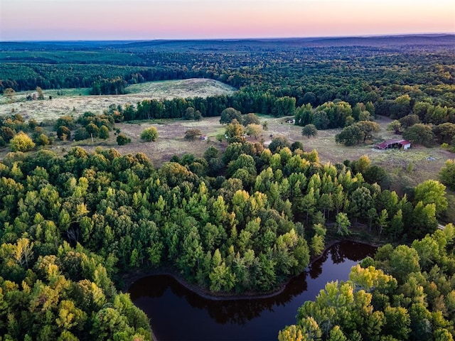 aerial view at dusk with a water view