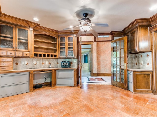 kitchen with decorative backsplash, french doors, ceiling fan, and ornamental molding