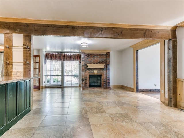 unfurnished living room featuring a fireplace and french doors