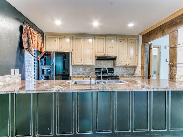 kitchen with black appliances, light stone counters, sink, and cream cabinets