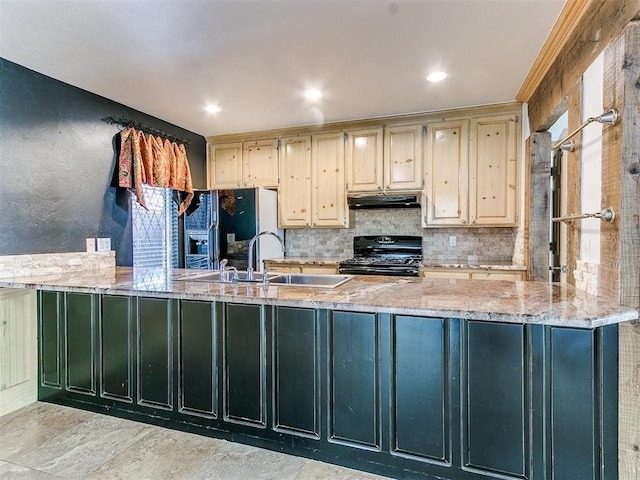 kitchen with kitchen peninsula, cream cabinetry, and black appliances