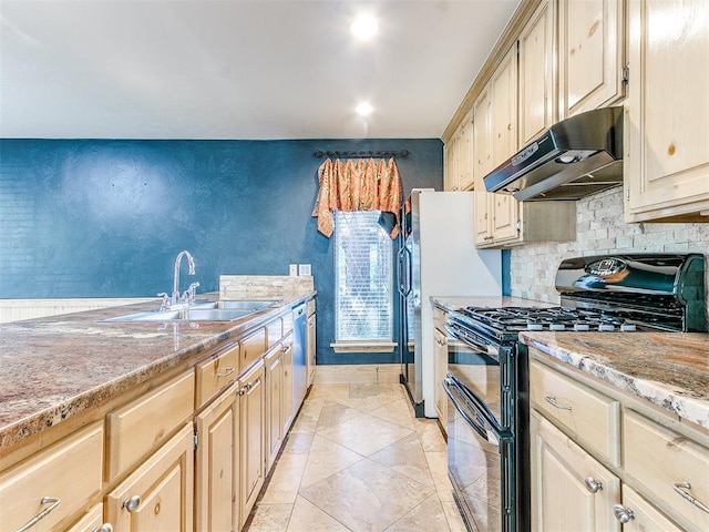 kitchen with light stone countertops, stainless steel dishwasher, gas stove, sink, and light brown cabinets