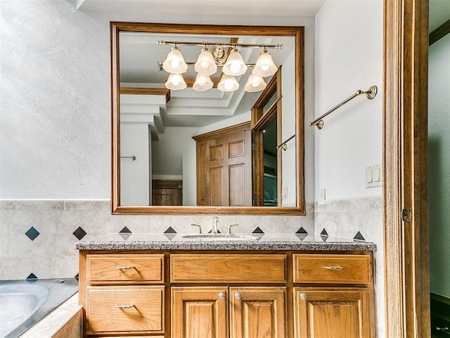 bathroom featuring vanity, a bathtub, and ornamental molding