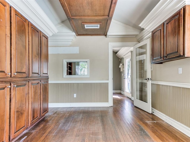 interior space featuring wood walls, crown molding, dark wood-type flooring, and french doors