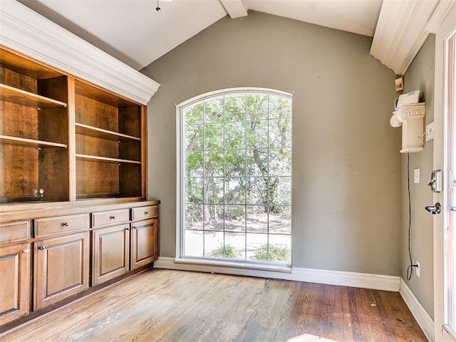 interior space featuring lofted ceiling with beams and light wood-type flooring