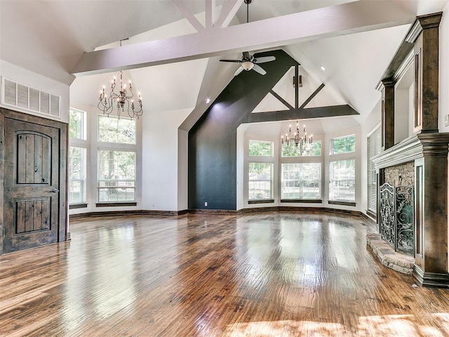 unfurnished living room with beam ceiling, hardwood / wood-style floors, and high vaulted ceiling