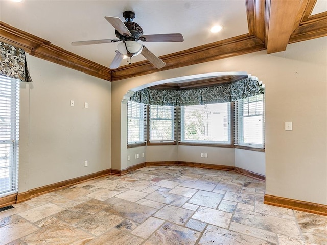 spare room featuring crown molding, ceiling fan, and a healthy amount of sunlight