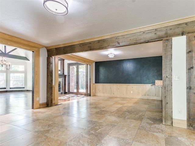 unfurnished room with plenty of natural light, a chandelier, and french doors