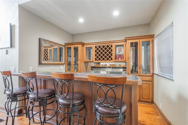 bar with light hardwood / wood-style floors