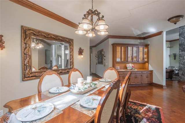 dining area featuring ceiling fan with notable chandelier, dark hardwood / wood-style floors, and ornamental molding