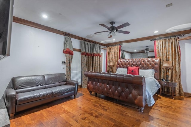 bedroom with hardwood / wood-style flooring, ceiling fan, and ornamental molding