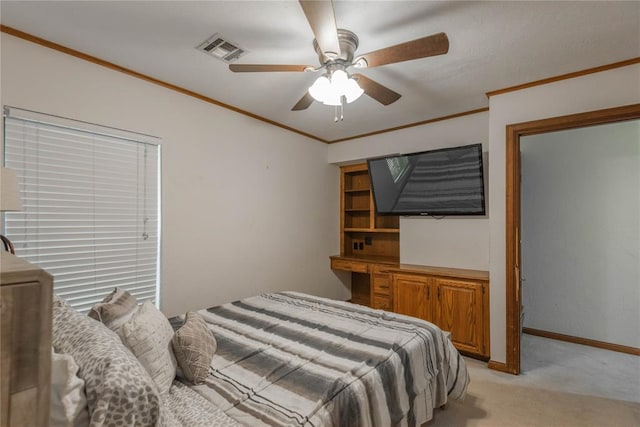 carpeted bedroom with ceiling fan and crown molding