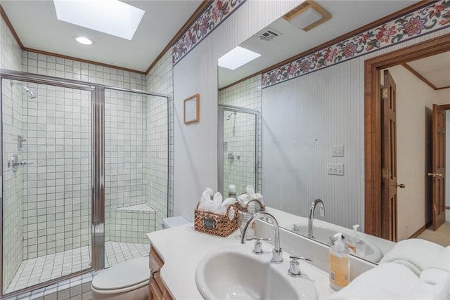 bathroom featuring vanity, a skylight, an enclosed shower, and ornamental molding