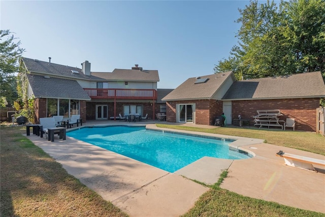 view of swimming pool with a lawn and a patio