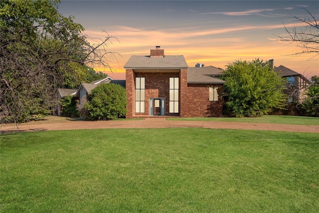 back house at dusk with a yard