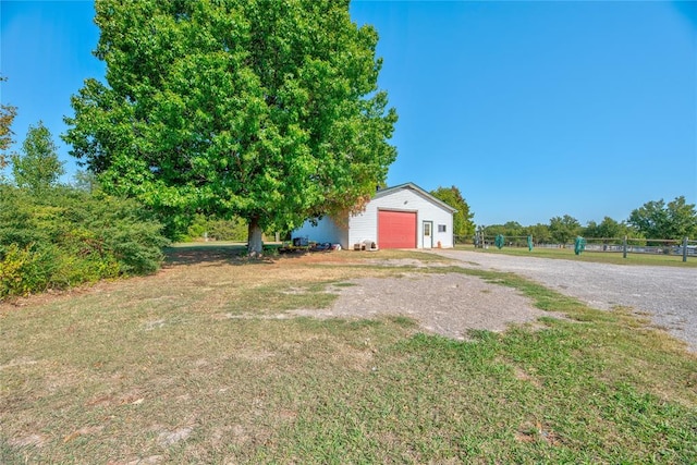 view of yard featuring an outbuilding and a garage