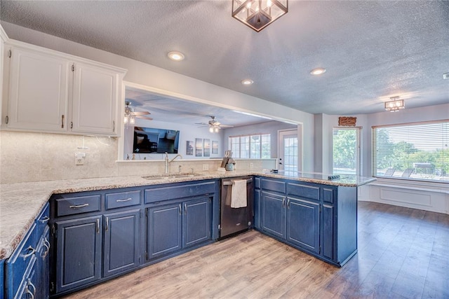 kitchen featuring dishwasher, white cabinetry, sink, kitchen peninsula, and blue cabinetry