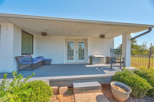 wooden deck with central AC unit and french doors