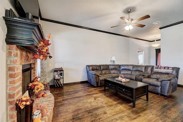 living room with ceiling fan, a fireplace, dark wood-type flooring, and ornamental molding