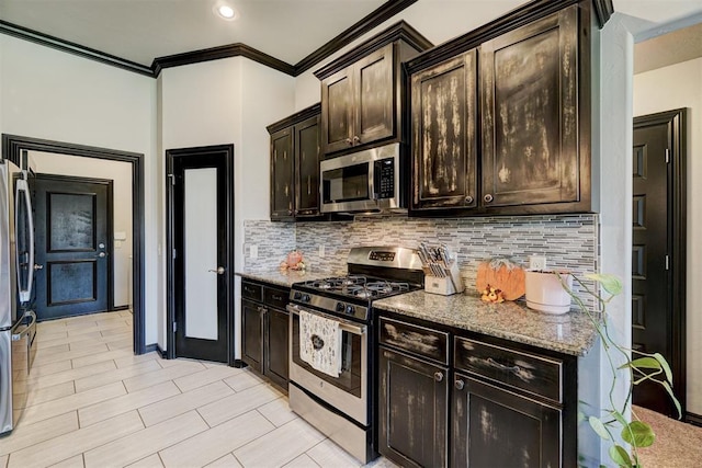 kitchen featuring stone counters, dark brown cabinets, crown molding, and appliances with stainless steel finishes