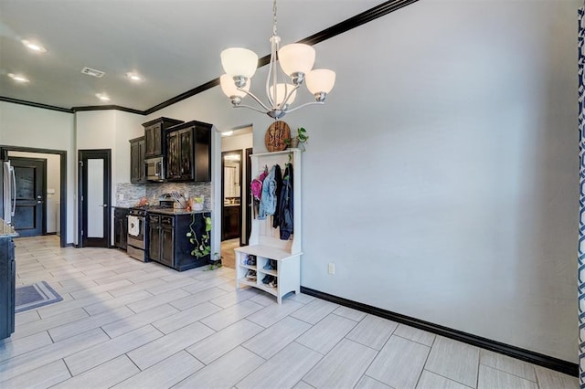 kitchen featuring dark brown cabinetry, hanging light fixtures, tasteful backsplash, a notable chandelier, and appliances with stainless steel finishes