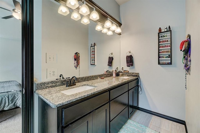 bathroom with ceiling fan and vanity