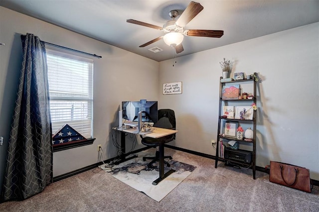 carpeted office space with ceiling fan