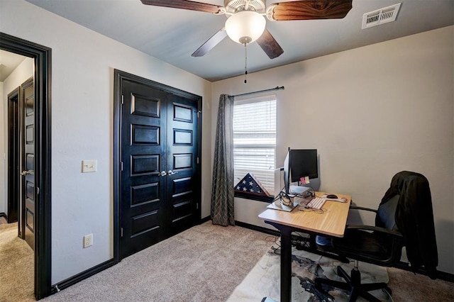 carpeted office space with ceiling fan