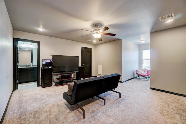 living room with ceiling fan and light colored carpet