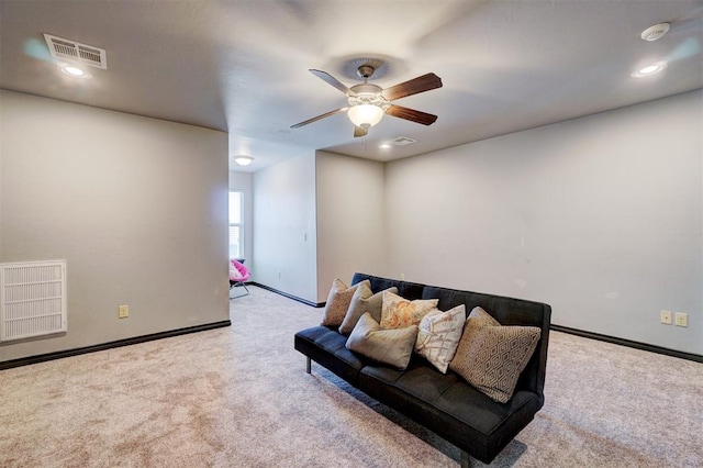 carpeted living room with ceiling fan