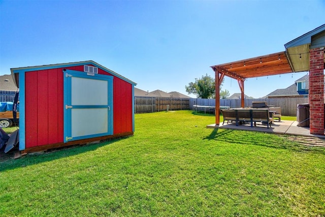 view of yard with a patio, a trampoline, and a shed