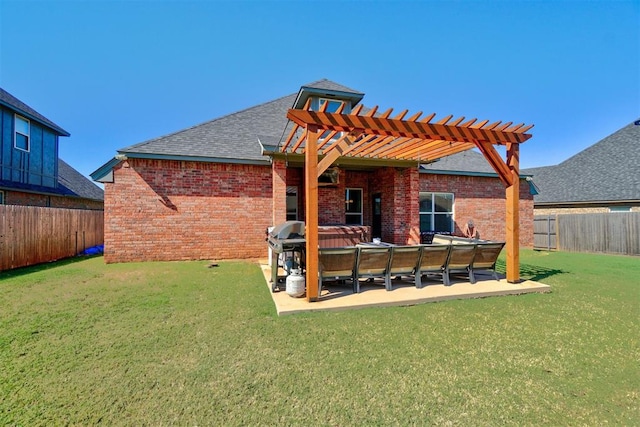 back of house featuring a lawn, a patio area, a pergola, and a hot tub