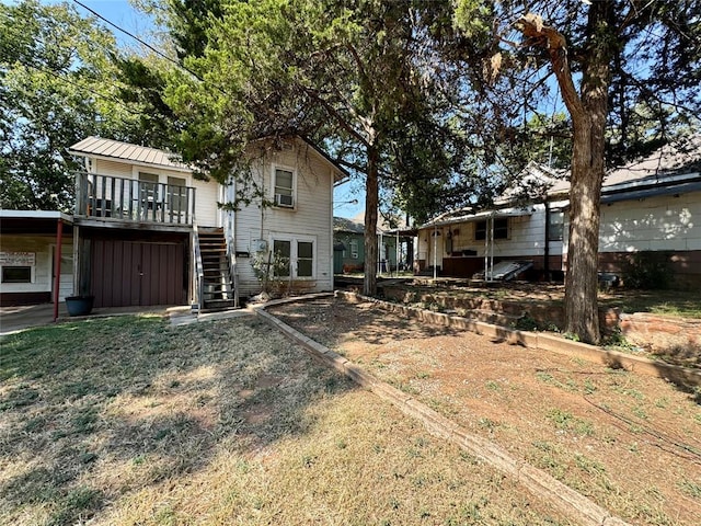 back of property featuring a wooden deck