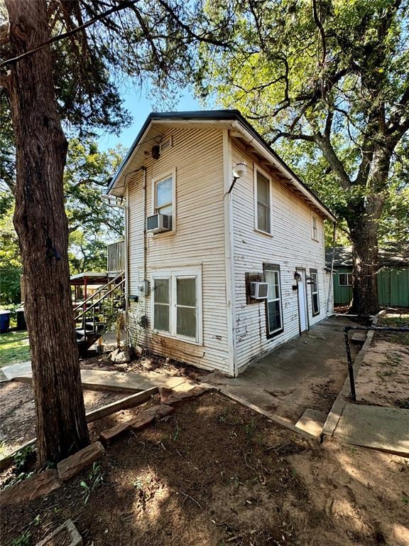 view of home's exterior with a patio area and cooling unit