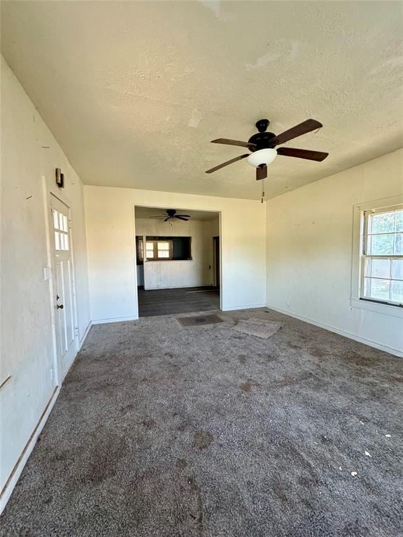 carpeted spare room featuring a textured ceiling