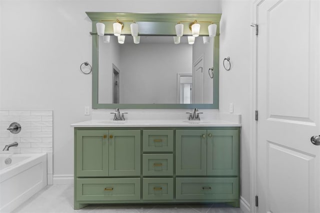 bathroom with tile patterned floors, a tub, and vanity