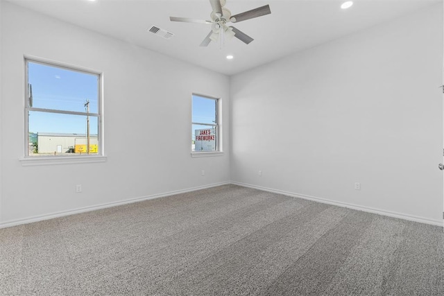 unfurnished room featuring carpet, plenty of natural light, and ceiling fan