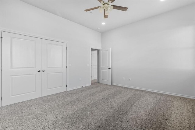 unfurnished bedroom featuring ceiling fan, a closet, and carpet floors