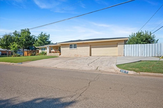 ranch-style house featuring a garage and a front yard