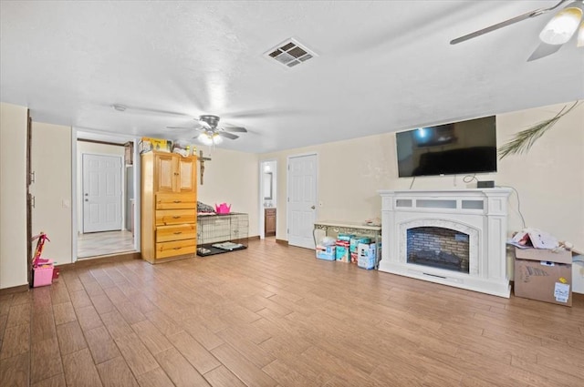 living room with hardwood / wood-style floors and ceiling fan