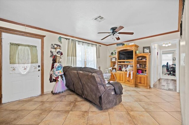 living room with plenty of natural light, ceiling fan, and ornamental molding