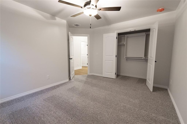 unfurnished bedroom with a ceiling fan, carpet, visible vents, and baseboards