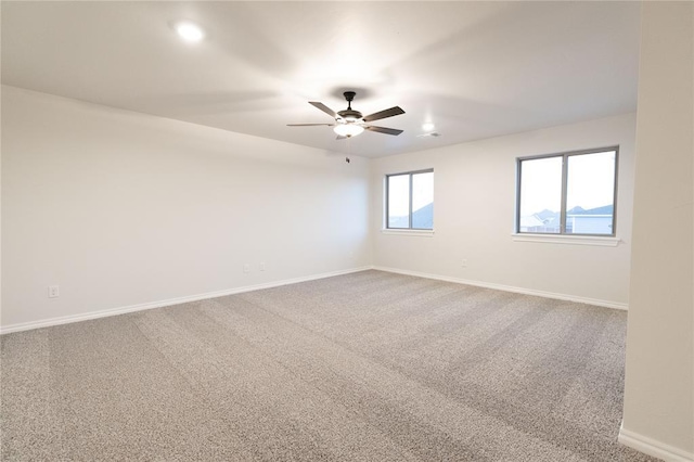 empty room featuring carpet flooring, ceiling fan, and baseboards