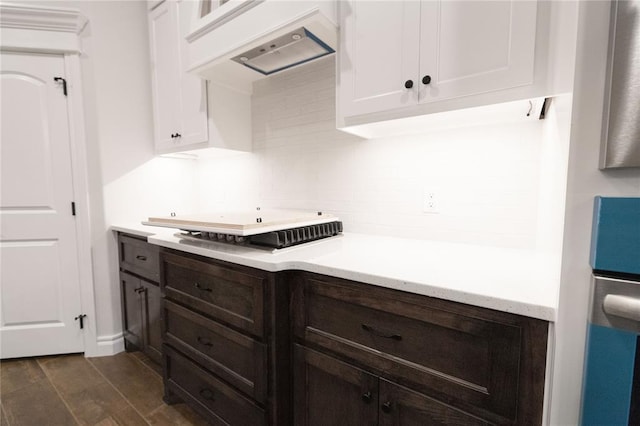 kitchen with dark brown cabinetry, dark wood finished floors, light countertops, premium range hood, and white cabinetry