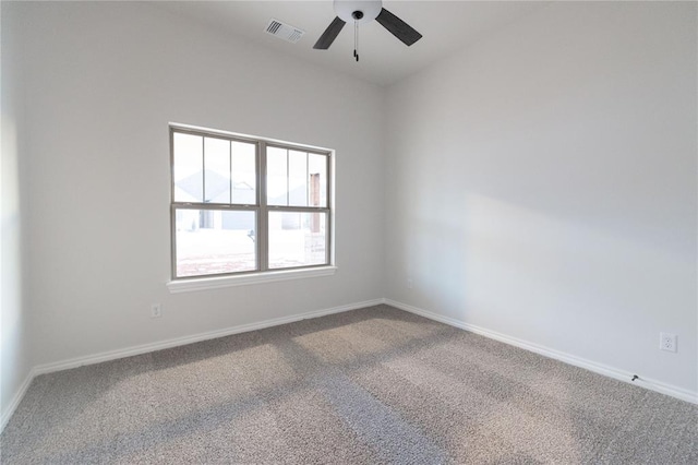 carpeted empty room with a ceiling fan, visible vents, and baseboards